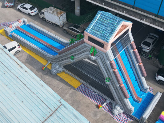 व्यावसायिक ग्रेड विशाल inflatable पानी स्लाइड, मनोरंजन पार्क और त्योहारों के लिए उष्णकटिबंधीय थीम वाली दोहरी लेन गीली/सूखी स्लाइड